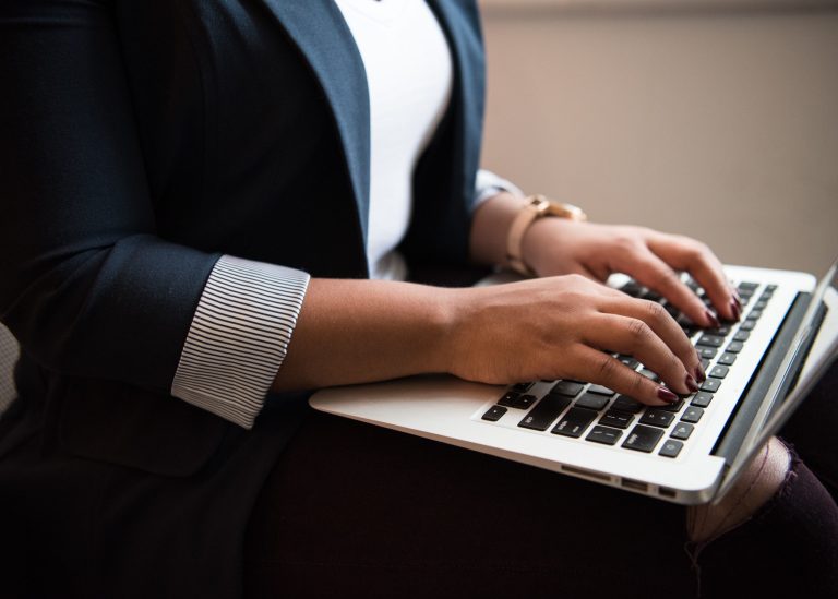 A woman typing on a computer.