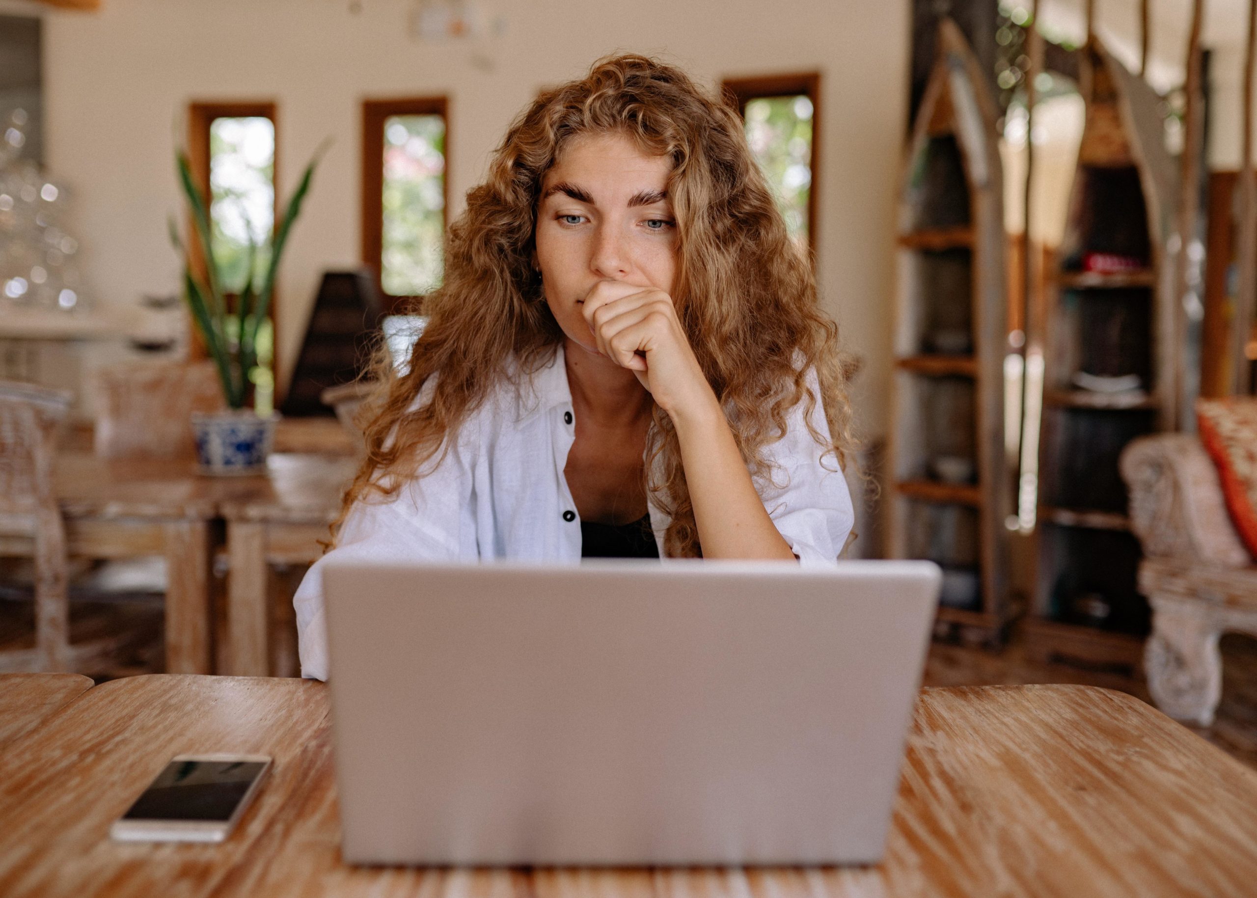 Person looking at their computer contemplating what social media platform they should prioritize for their business.