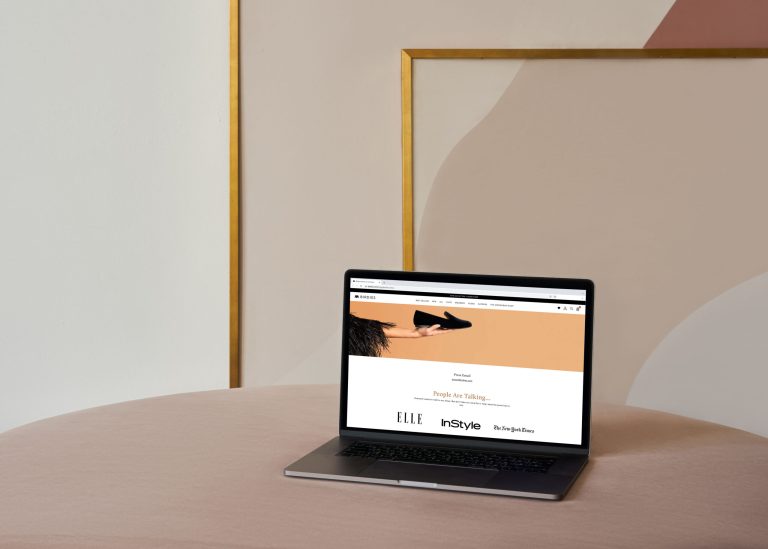 A computer displaying a company's press page sitting on a desk.