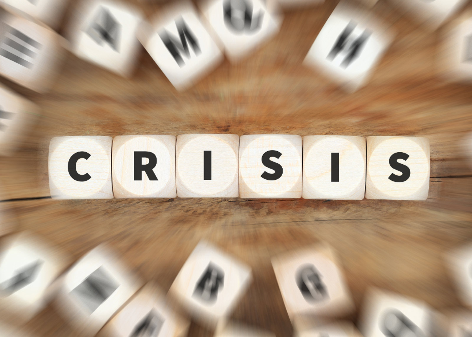 word game cubes spelling out "CRISIS"