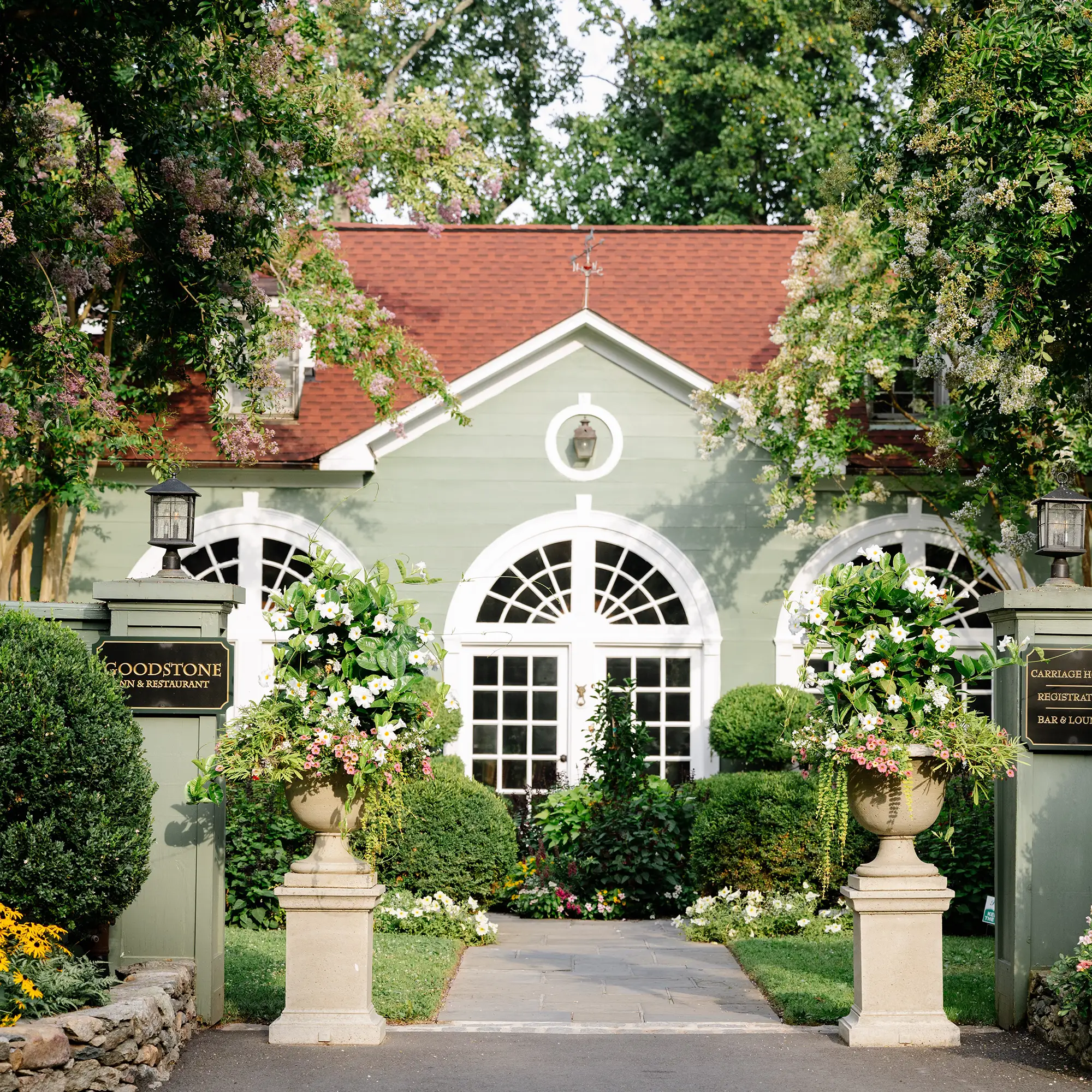 exterior of a carriage house with red roof
