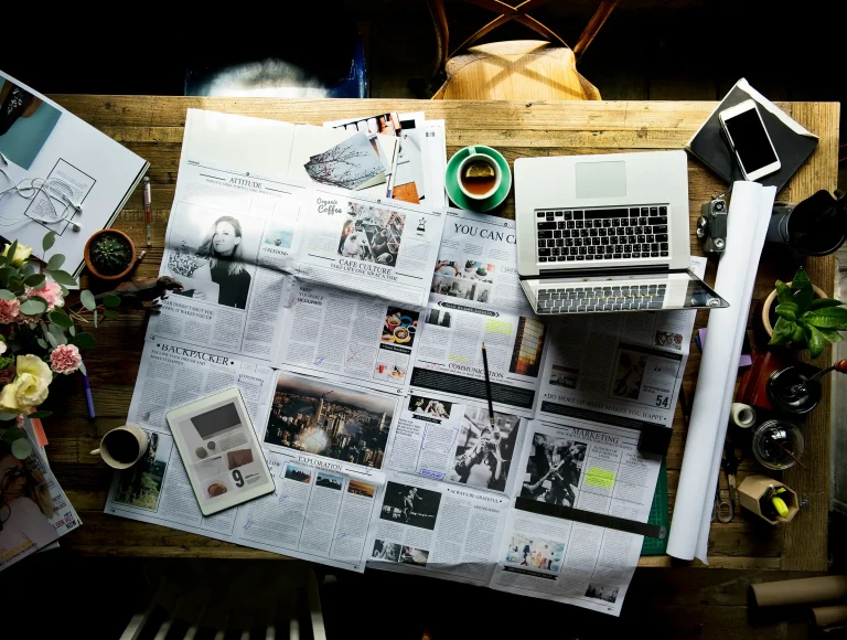 a printed layout on a table with a laptop